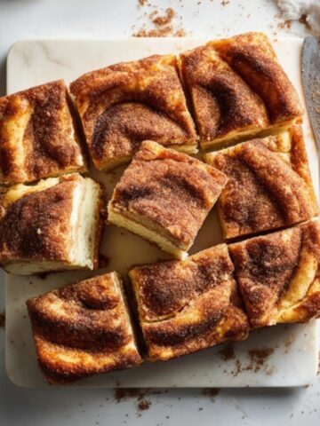 Homemade churro cheesecake bars with cinnamon sugar topping