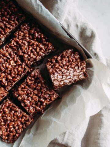 homemade chocolate crunch bars on white kitchen counter