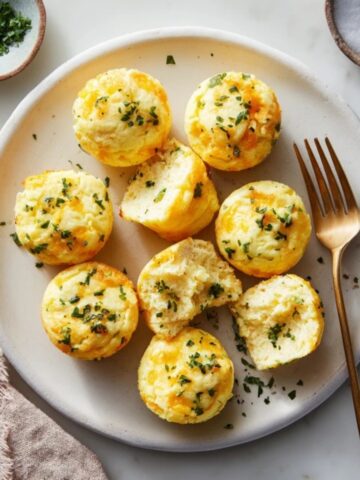 Fluffy high-protein egg bites on a plate with herbs