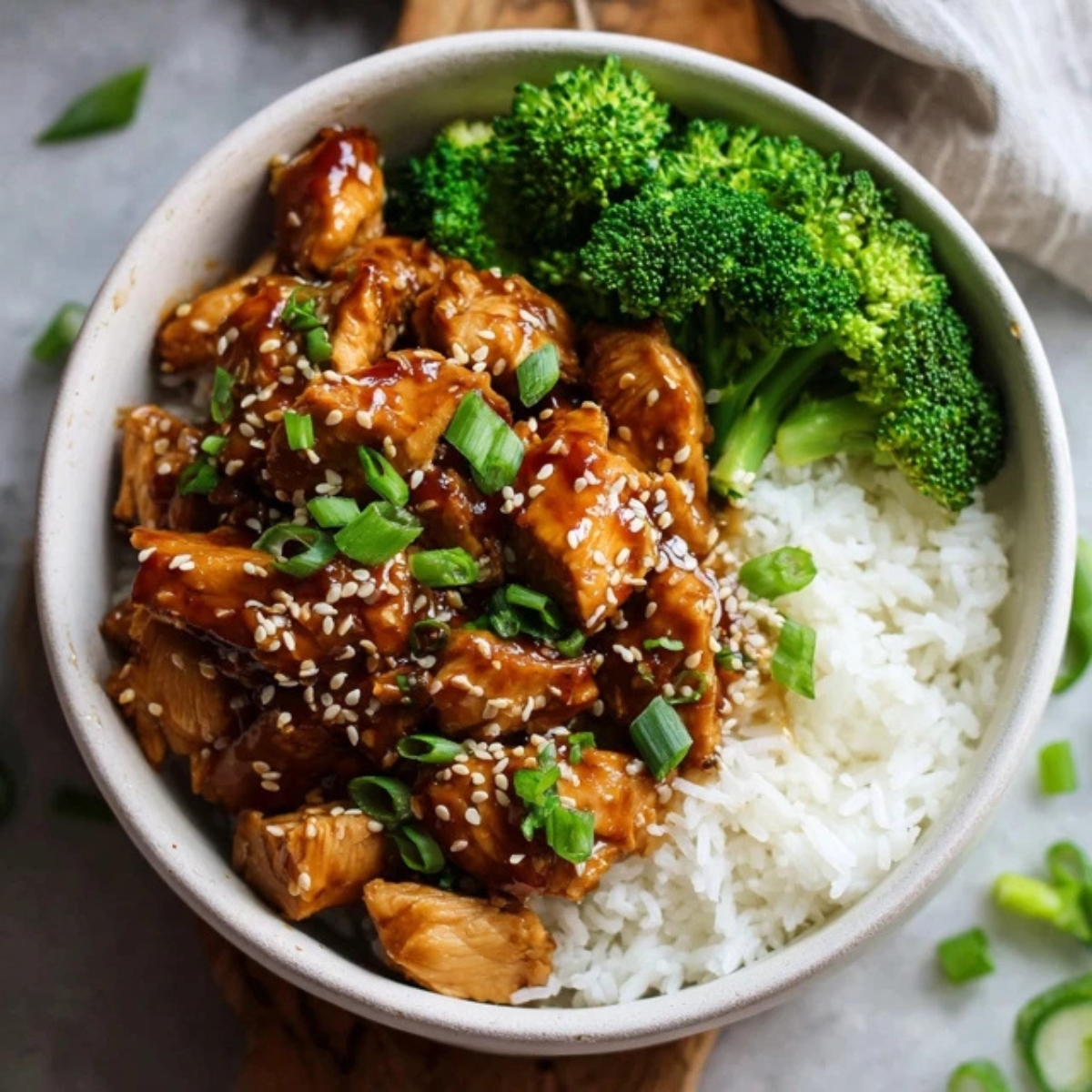 Instant Pot teriyaki chicken served over rice with sesame seeds and green onions
