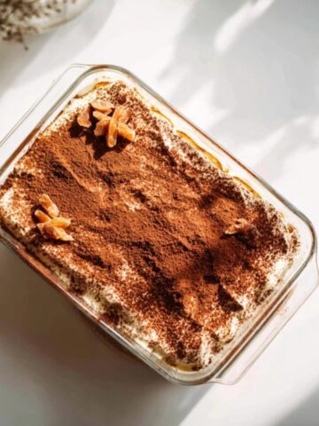 pumpkin chai tiramisu with cocoa and cinnamon dusting on white counter