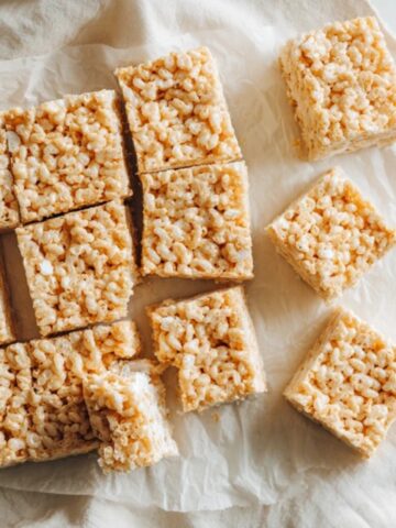 gooey homemade rice krispies treats cut into squares on white counter