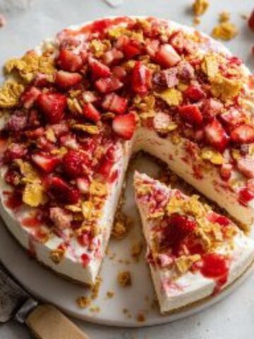 No bake strawberry crunch cheesecake with golden Oreo crust and fresh strawberry topping