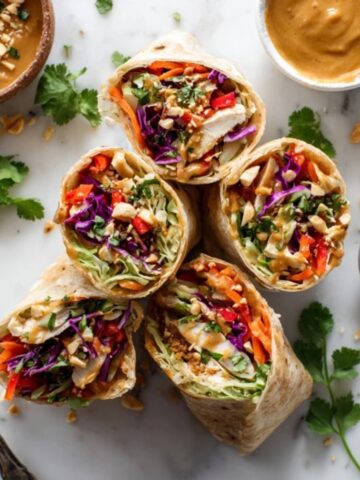 Thai Peanut Chicken Wraps with peanut sauce on white kitchen counter