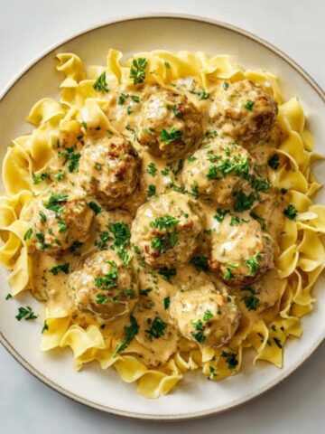 homemade turkey swedish meatballs with creamy gravy over noodles