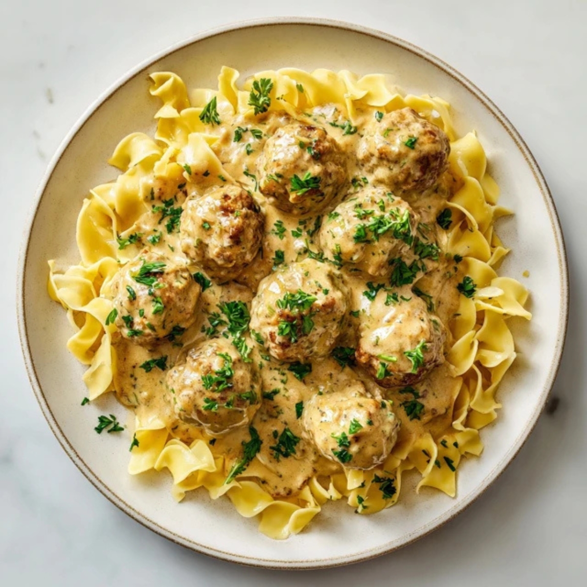 homemade turkey swedish meatballs with creamy gravy over noodles