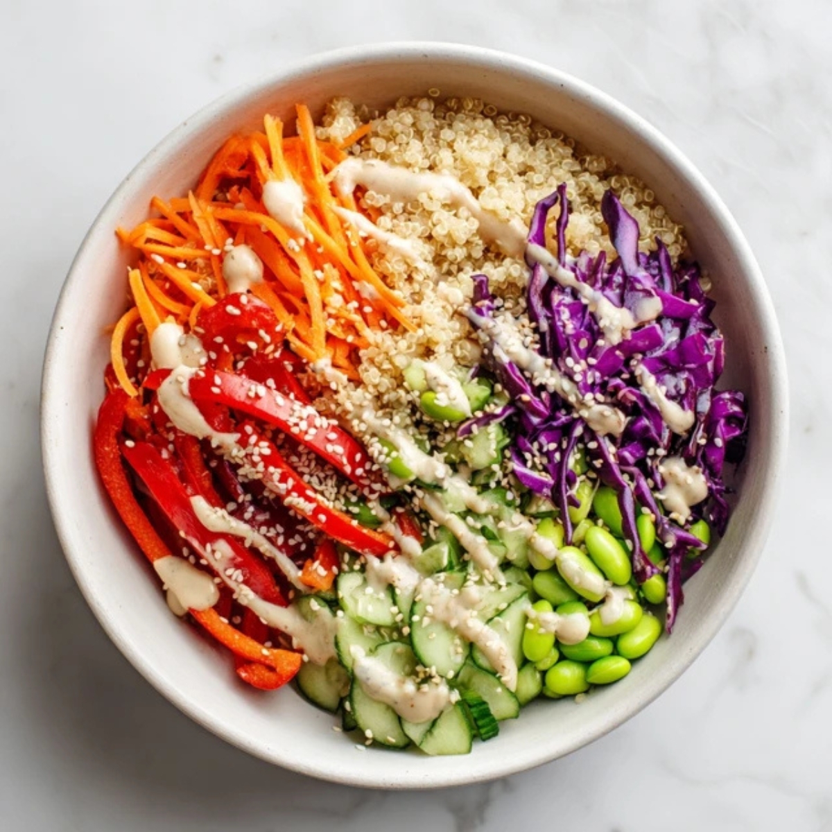 Healthy Asian quinoa bowl with sesame ginger dressing on white kitchen counter