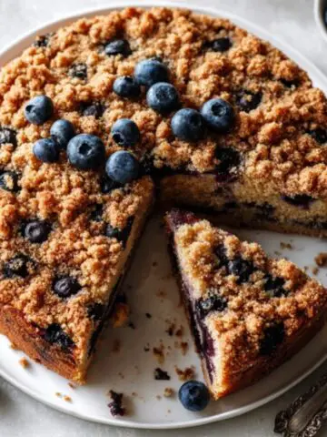 Homemade blueberry buckle with streusel topping on white counter