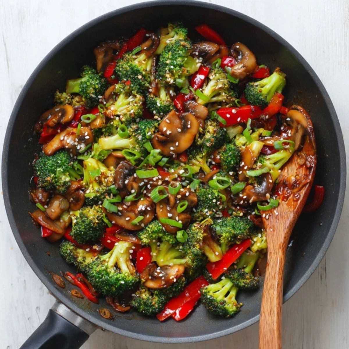 Homemade broccoli and mushroom stir fry in wok with sesame seeds