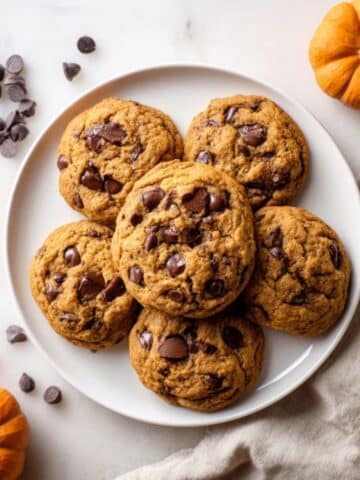 soft brown butter pumpkin chocolate chip cookies on white counter