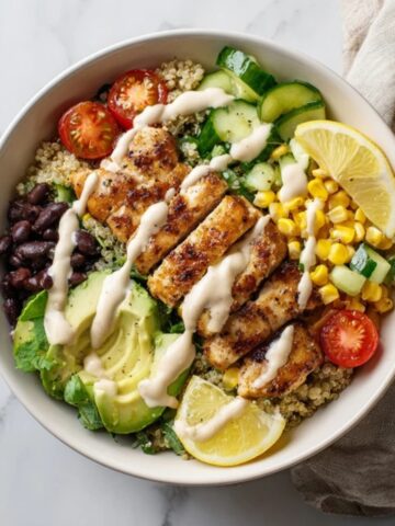 healthy chicken quinoa bowl with honey garlic chicken and tahini dressing