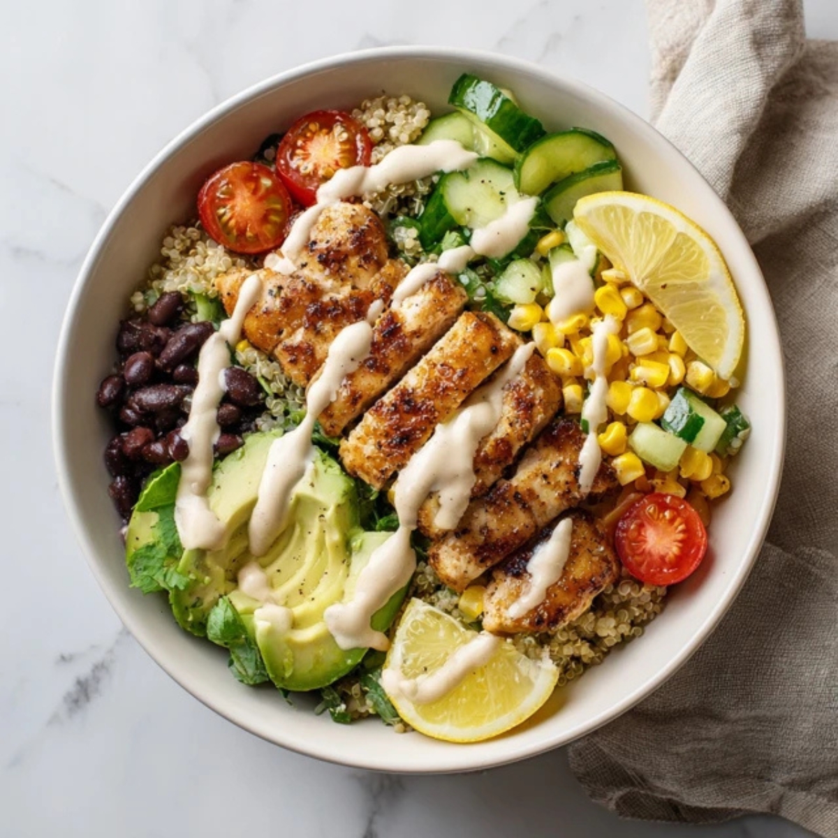healthy chicken quinoa bowl with honey garlic chicken and tahini dressing