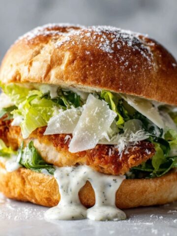 crispy chicken caesar sandwich on toasted brioche bun with lettuce and parmesan