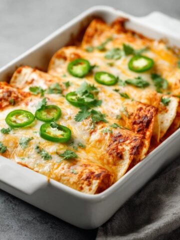Easy homemade chicken enchiladas with melted cheese and sauce