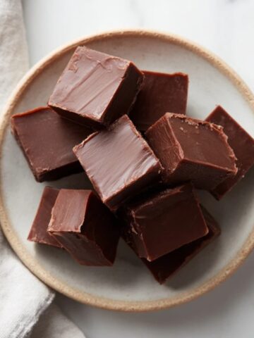 homemade chocolate fudge recipe squares on white kitchen counter