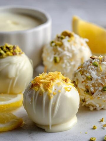 Homemade lemon truffles with white chocolate and lemon zest on a kitchen counter