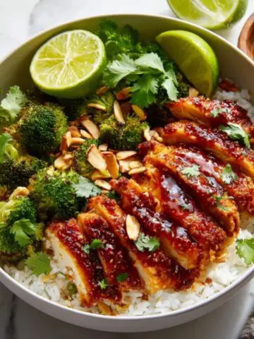 Hot Honey Chicken Bowl with rice and vegetables on white kitchen counter