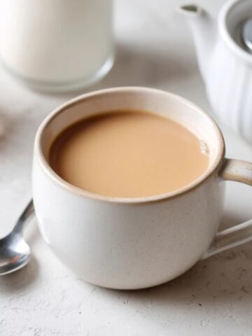 Creamy Japanese royal milk tea in a cozy mug on a white kitchen counter