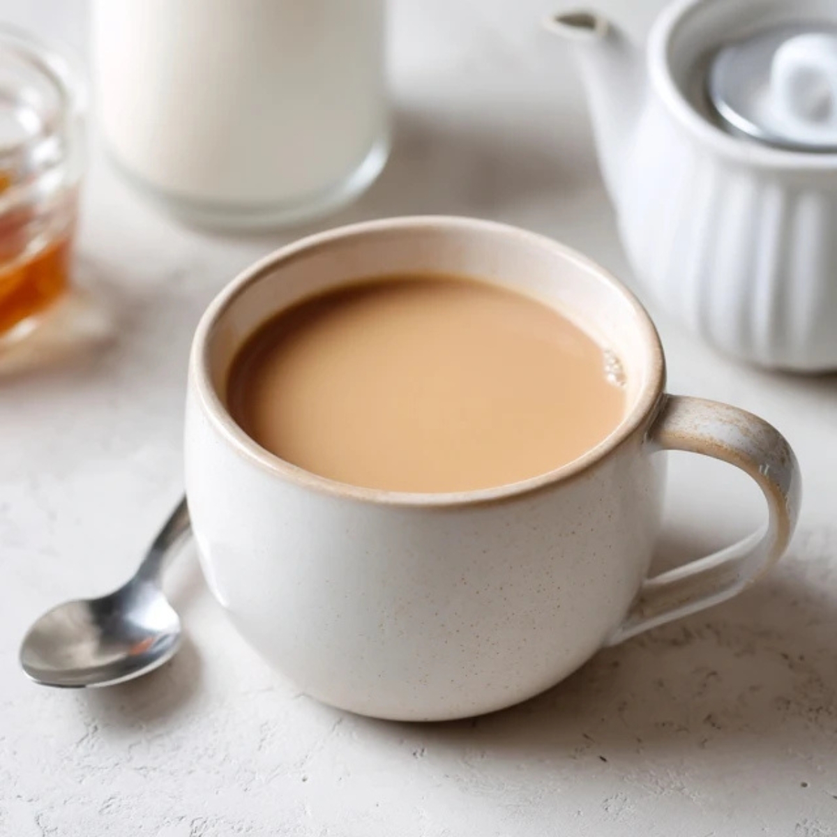 Creamy Japanese royal milk tea in a cozy mug on a white kitchen counter