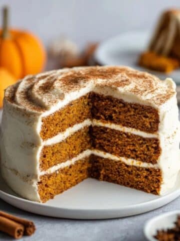 moist pumpkin layer cake with cream cheese frosting on a white kitchen counter