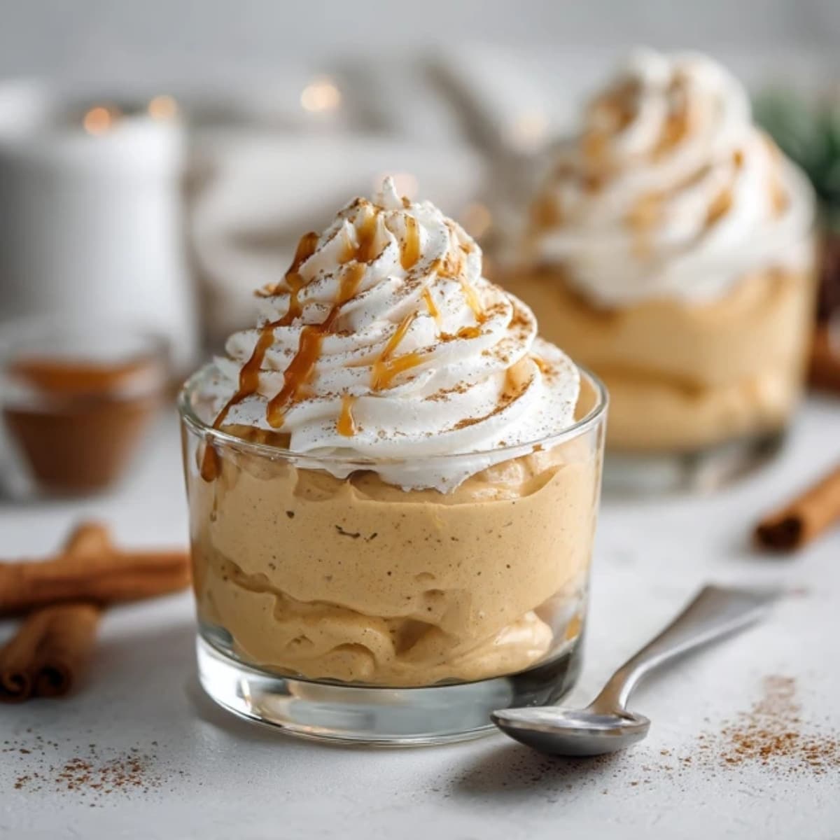 creamy pumpkin mousse dessert topped with whipped cream and cinnamon