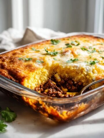golden tamale pie casserole with cornbread topping on white kitchen counter