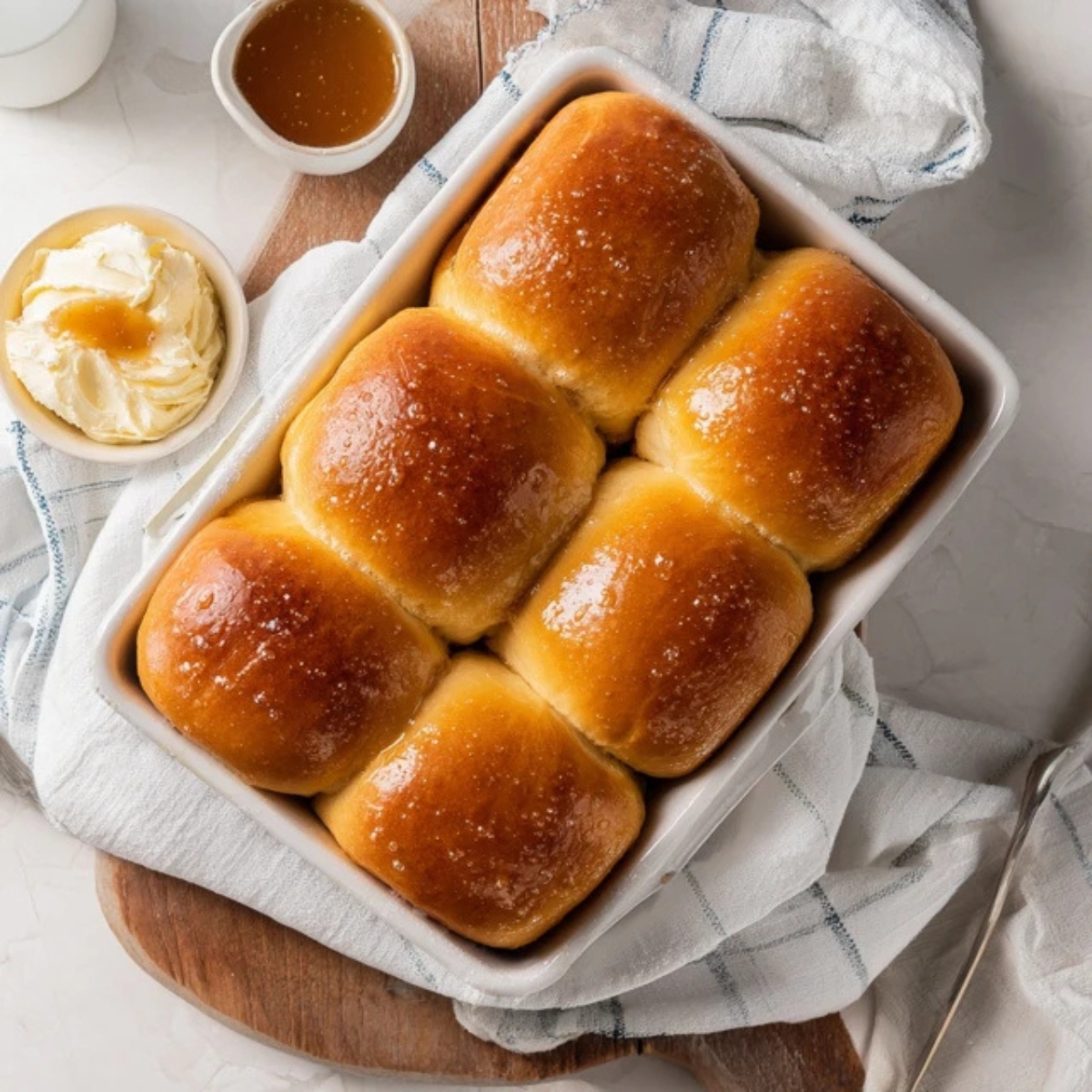 freshly baked texas roadhouse rolls with cinnamon honey butter on white kitchen counter